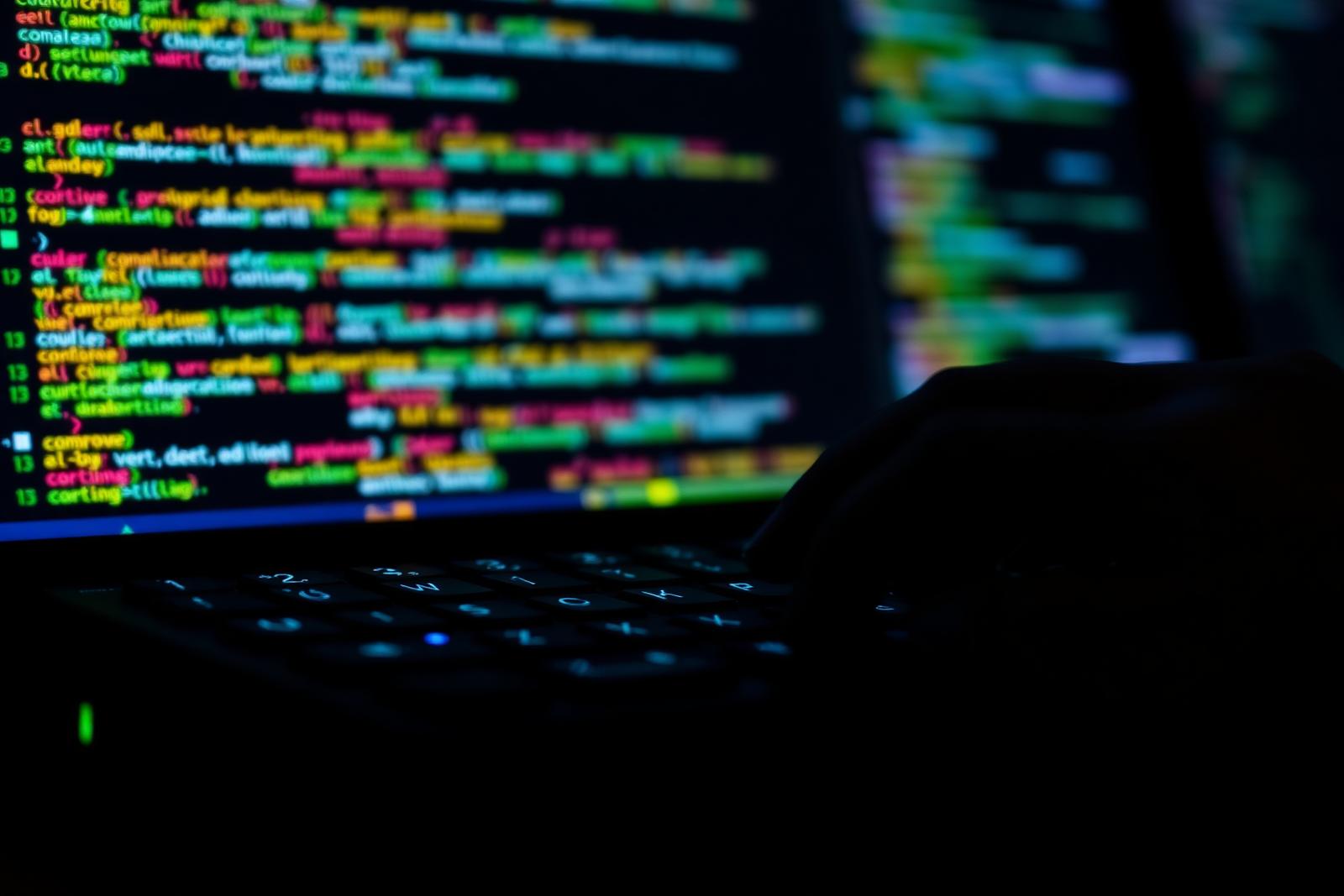 Developer keyboard illuminated by colorful code